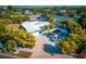 A beautiful home showcasing a long driveway and lush landscaping in an established neighborhood at 2159 Constitution Blvd, Sarasota, FL 34231
