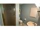 Bathroom with walk-in shower, blue paint, and a light fixture at 2159 Constitution Blvd, Sarasota, FL 34231