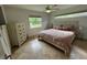 Bright bedroom with large windows, a ceiling fan, and a wooden dresser at 2159 Constitution Blvd, Sarasota, FL 34231
