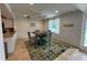 Casual dining area featuring a colorful rug, view of the kitchen, and inviting natural light at 2159 Constitution Blvd, Sarasota, FL 34231