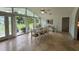 Bright dining area featuring tile floors, an open floor plan, and a large window with garden views at 2159 Constitution Blvd, Sarasota, FL 34231