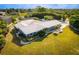 Charming exterior showcasing a well-maintained home with lush landscaping and a metal roof at 2159 Constitution Blvd, Sarasota, FL 34231
