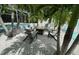 Outdoor fire pit surrounded by Adirondack chairs and shaded by palm trees at 2159 Constitution Blvd, Sarasota, FL 34231