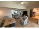 Open living area with comfortable seating, tile flooring and a view to dining and kitchen at 2159 Constitution Blvd, Sarasota, FL 34231