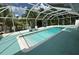 Beautiful backyard pool area with a screened enclosure and an outdoor seating area with lounge chairs at 2159 Constitution Blvd, Sarasota, FL 34231