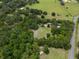 Aerial view showing the property and its proximity to open fields at 22063 Lake Lindsey Rd, Brooksville, FL 34601