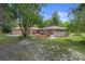 Expansive backyard with wooden deck for outdoor entertaining and lush green space at 22063 Lake Lindsey Rd, Brooksville, FL 34601