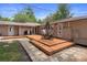 Backyard features a wooden deck, garden with a stone border, and manicured landscaping at 22063 Lake Lindsey Rd, Brooksville, FL 34601