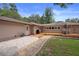 Exterior view showing a stone path to wooden deck and outdoor living space at 22063 Lake Lindsey Rd, Brooksville, FL 34601