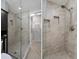 Bathroom featuring a luxurious tiled shower with glass door and a built-in niche at 22063 Lake Lindsey Rd, Brooksville, FL 34601