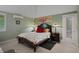 Comfortable bedroom featuring a decorative quilt, bedside tables with lamps, and access to the outside at 22063 Lake Lindsey Rd, Brooksville, FL 34601