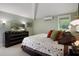 Comfortable bedroom featuring soft carpet, neutral paint, modern lighting, and view to backyard at 22063 Lake Lindsey Rd, Brooksville, FL 34601