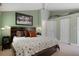 Comfortable bedroom featuring soft carpet, neutral paint, modern lighting, and generous closet space at 22063 Lake Lindsey Rd, Brooksville, FL 34601