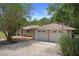 A ranch-style home with an attached two-car garage, highlighted by a well-manicured lawn at 22063 Lake Lindsey Rd, Brooksville, FL 34601