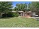 Ranch home with deck and two car garage amid lush lawns and trees at 22063 Lake Lindsey Rd, Brooksville, FL 34601