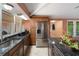 Updated kitchen with stainless steel refrigerator, granite countertops, and breakfast bar seating at 22063 Lake Lindsey Rd, Brooksville, FL 34601