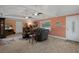 Bright living room with tile flooring, a ceiling fan, and views to the outside at 22063 Lake Lindsey Rd, Brooksville, FL 34601