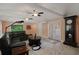Cozy living room featuring tile floors, ceiling fans, and large windows at 22063 Lake Lindsey Rd, Brooksville, FL 34601