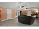 Comfortable living room featuring tile floors, three ceiling fans, and plenty of natural light at 22063 Lake Lindsey Rd, Brooksville, FL 34601