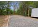 Gravel RV parking space showcasing a dedicated spot for recreational vehicle, electric hookup, and utility pole at 22063 Lake Lindsey Rd, Brooksville, FL 34601