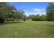 Large property with a well-manicured lawn, shade trees and a spacious home at 22063 Lake Lindsey Rd, Brooksville, FL 34601