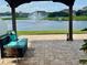 Serene backyard view from patio with lake, fountain, and manicured lawn at 2410 Mizner Bay Ave, Bradenton, FL 34208
