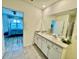 Bathroom with double sinks, white cabinets, and view of the bedroom at 2410 Mizner Bay Ave, Bradenton, FL 34208