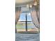 Window view from bedroom featuring a lake with fountain and seating area at 2410 Mizner Bay Ave, Bradenton, FL 34208