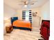 Cozy bedroom with bright orange bedspread, ceiling fan, and wood-look flooring at 2410 Mizner Bay Ave, Bradenton, FL 34208