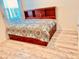 Comfortable bedroom featuring a wooden headboard with storage and patterned bedding at 2410 Mizner Bay Ave, Bradenton, FL 34208