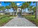 Community clubhouse entrance with manicured landscaping and inviting walkway at 2410 Mizner Bay Ave, Bradenton, FL 34208