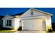 Charming single-story home featuring a two-car garage and meticulously maintained landscaping at 2410 Mizner Bay Ave, Bradenton, FL 34208