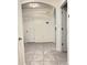Neutral-toned hallway with tiled floor with a clean aesthetic at 2410 Mizner Bay Ave, Bradenton, FL 34208