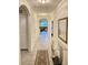 Inviting hallway featuring tile floors and archways leading to other areas of the home at 2410 Mizner Bay Ave, Bradenton, FL 34208