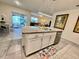 Bright kitchen with island, granite countertops, stainless steel appliances, and pendant lighting at 2410 Mizner Bay Ave, Bradenton, FL 34208