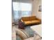 Bright living room with large window, modern sofa, and colorful accent pillow at 2410 Mizner Bay Ave, Bradenton, FL 34208