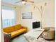 Well-lit home office with modern desk, colorful sofa, and bright decor at 2410 Mizner Bay Ave, Bradenton, FL 34208