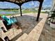Covered patio with stylish seating and views of the beautiful lake and fountain at 2410 Mizner Bay Ave, Bradenton, FL 34208