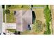 Aerial view of a one-story home with a driveway and a well-maintained lawn on a sunny day at 2420 16Th W St, Palmetto, FL 34221