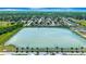 Expansive aerial view of a residential community with a large lake, showcasing the neighborhood's serene setting at 2420 16Th W St, Palmetto, FL 34221