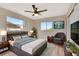 Tastefully decorated bedroom featuring wood-look floors, a ceiling fan, and a mounted TV at 2420 16Th W St, Palmetto, FL 34221