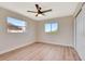 Spacious bedroom with wood-look floors, bright walls, and two windows at 2420 16Th W St, Palmetto, FL 34221