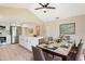 Bright dining area featuring a marble-top table, pendant light fixture, and seamlessly connected to a modern kitchen at 2420 16Th W St, Palmetto, FL 34221