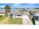 Charming single-story home features a well-maintained lawn, palm tree, and a lovely waterfront view at 2420 16Th W St, Palmetto, FL 34221