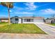 Inviting single-story home with a lush green lawn and a convenient two-car garage at 2420 16Th W St, Palmetto, FL 34221