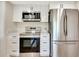 This kitchen boasts stainless steel appliances, white cabinets, and quartz countertops, offering a sleek and modern design at 2420 16Th W St, Palmetto, FL 34221
