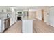 Bright kitchen boasts a large island with quartz countertops, stainless steel appliances, and white cabinets at 2420 16Th W St, Palmetto, FL 34221