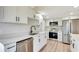Modern kitchen featuring white cabinets, stainless steel appliances, quartz countertops, and a sleek black faucet at 2420 16Th W St, Palmetto, FL 34221