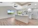 Open concept kitchen with an island, stainless steel appliances, white cabinets, and a window view at 2420 16Th W St, Palmetto, FL 34221