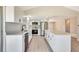 The kitchen boasts sleek white cabinetry, stainless steel appliances, and a large island with quartz countertops at 2420 16Th W St, Palmetto, FL 34221